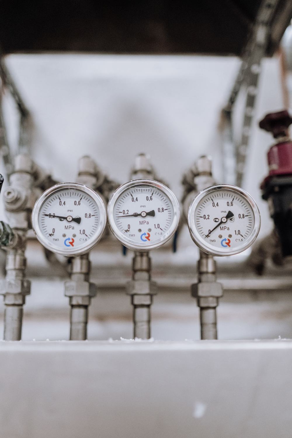Row of pressure gauges on process pipework