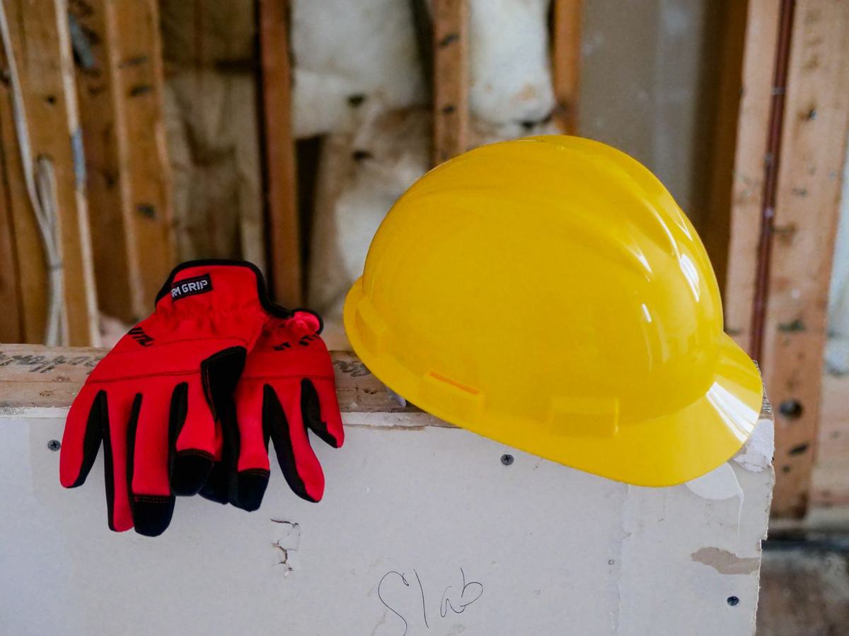 Yellow safety helmet and red work gloves