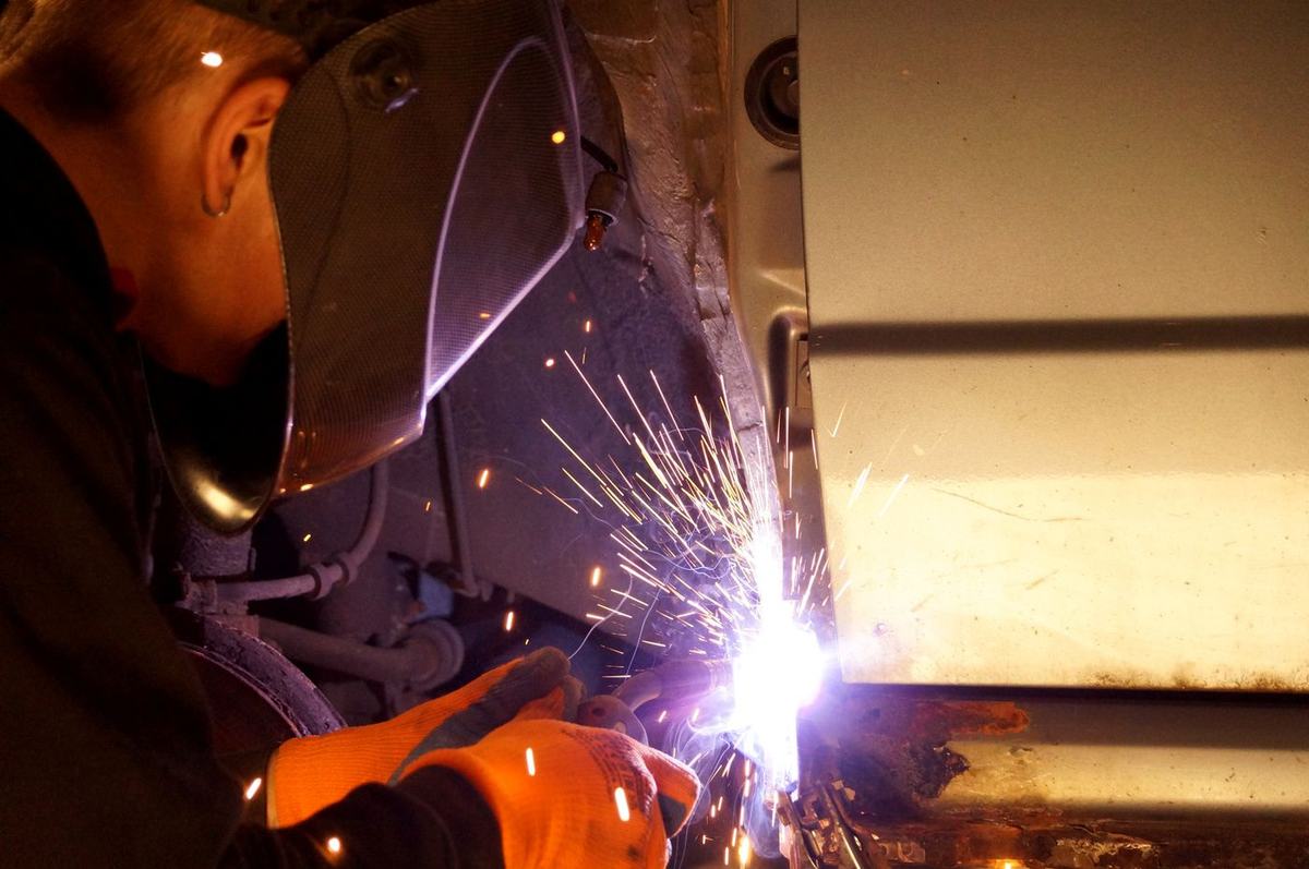 Welder at work with sparks from the torch